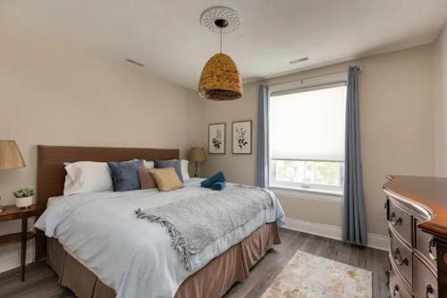 a bedroom with a large bed and a window at Casa Hotels in Toronto