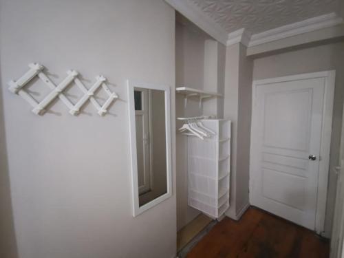 a room with a closet with a mirror and a door at Konut Wooden House in Istanbul