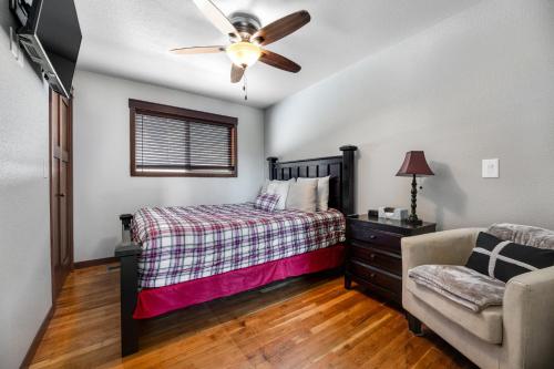 a bedroom with a bed and a couch and a ceiling fan at Whitegate Lodge in Piedmont