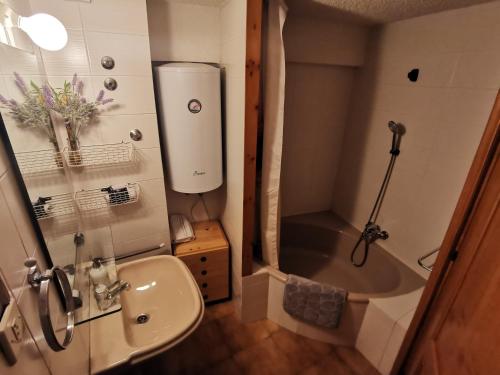 a bathroom with a shower and a sink and a tub at Dúplex con terraza y vistas panorámicas en Taüll in Taull
