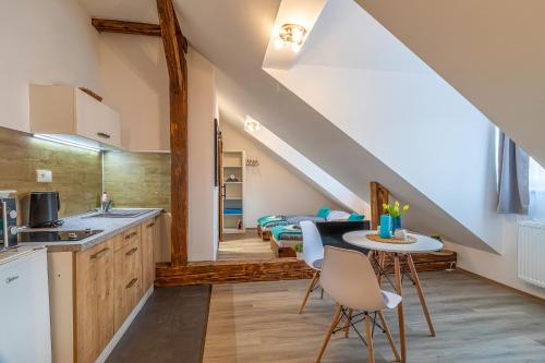 a kitchen and living room with a table and chairs at Jonas Apartments - Great Location near Bratislava City Center in Bratislava