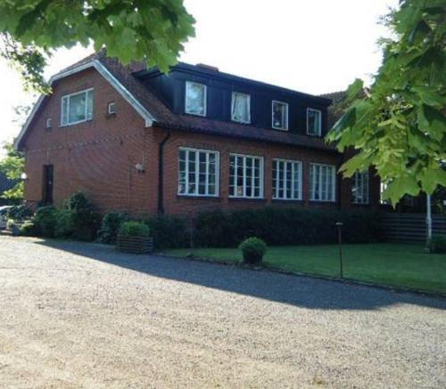 a large red brick house with a lot of windows at Wramsta B&B in Tollarp