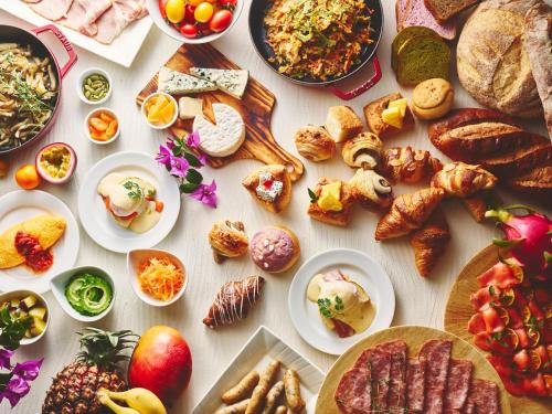 a table with many different types of food on it at ANA InterContinental Manza Beach Resort by IHG in Onna