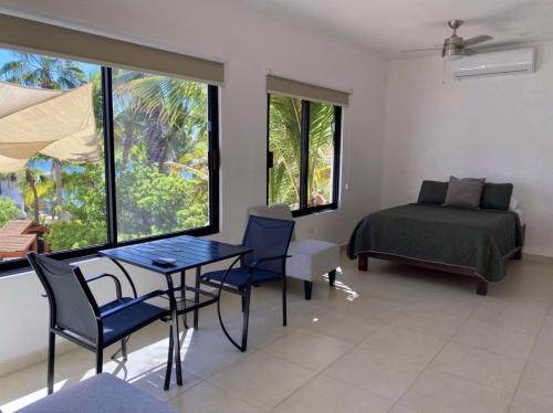 a bedroom with a bed and a table and chairs at Villa Paraíso in La Ventana
