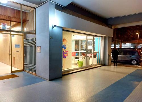 a store front with glass doors and a person standing outside at Appartamento CasaZeta luminoso e centralissimo in Latina