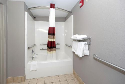 a bathroom with a bath tub and a shower at Red Roof Inn & Suites Carrollton, GA - West Georgia in Carrollton