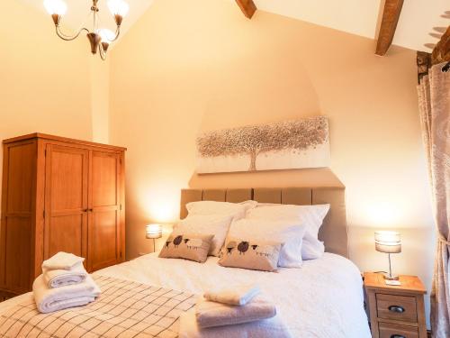 a bedroom with a bed with two towels on it at Sarah's Cottage in Bridlington