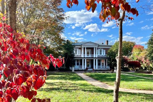 a white house with red leaves in front of it at Stonegate in Lexington