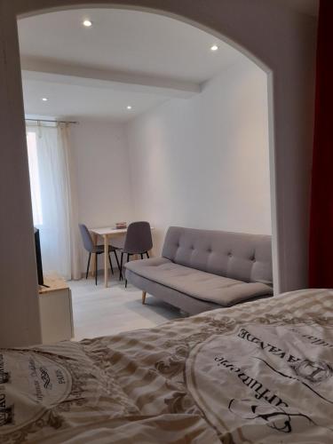 a living room with a couch and a table at studio 29 rue des potiers in Fréjus