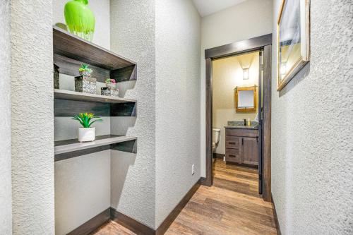 a hallway with a bathroom with a toilet and a sink at Pillar Peak Perch in Sturgis