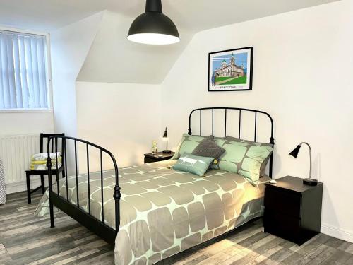 a bedroom with a large bed and a lamp at Harland View Apartment in Belfast