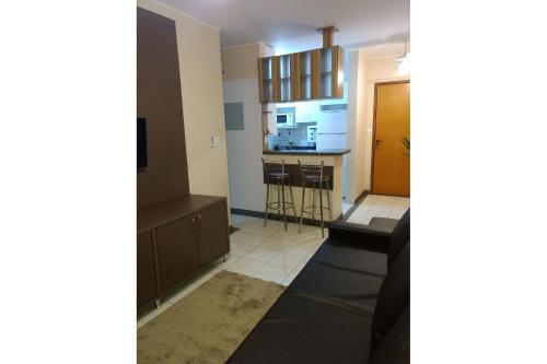 a view of a living room with a kitchen at Thermas Paradise Rio Quente Flats 319 in Rio Quente