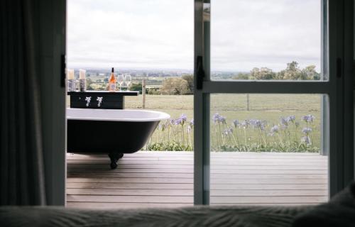a bath tub in a room with a window at Birds Eye View in Havelock North