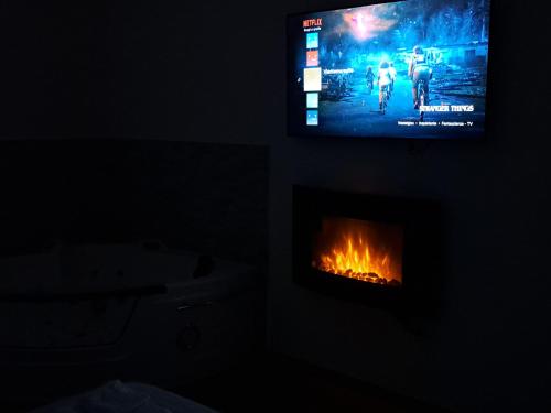 a living room with a television and a fireplace at Vient' e mar suite in Castellammare di Stabia