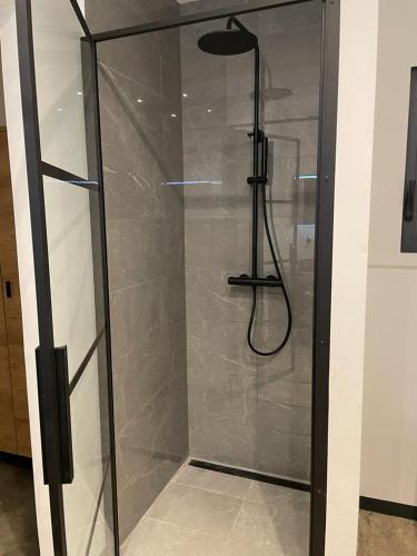 a shower with a glass door in a bathroom at Belnem Seaview Rooftop in Kralendijk
