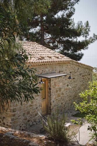 a stone building with a wooden door in a yard at Masseria Agriturismo Torre Di Albidona in Trebisacce