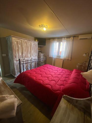 a bedroom with a large red bed in a room at B&B Snow Village Roccaraso in Roccaraso