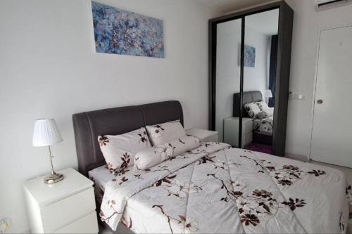 a white bedroom with a bed and a mirror at Equine Residence Getaway in Seri Kembangan