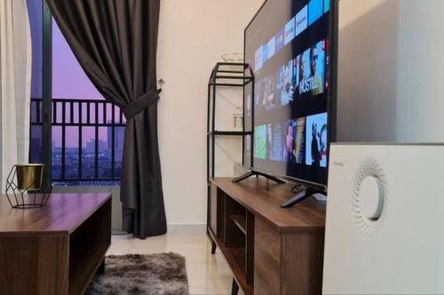 a living room with a flat screen tv and a window at Equine Residence Getaway in Seri Kembangan