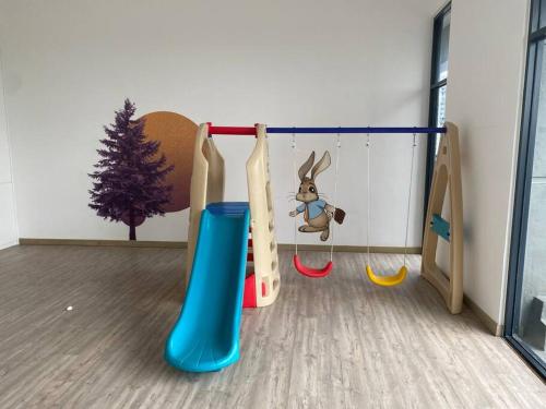 a childrens play room with a play equipment with a christmas tree at Equine Residence Getaway in Seri Kembangan