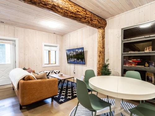 a living room with a table and a couch at ArborMyst in Glacier