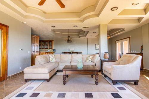 a living room with two couches and a table at Lighthouse Beach Villas in San Pedro