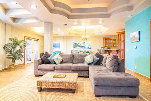 a living room with a couch and a table at Lighthouse Beach Villas in San Pedro