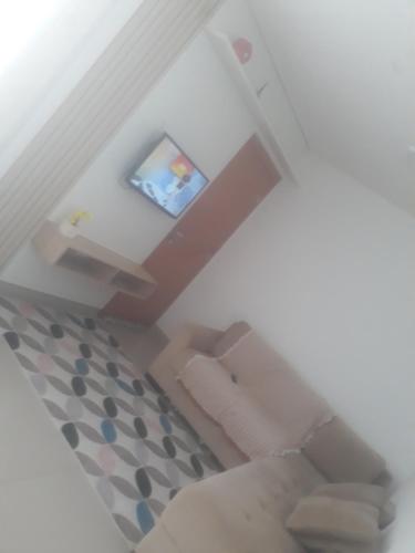 a view of a living room with a couch and a television at Apartamento em Cuiabá in Cuiabá