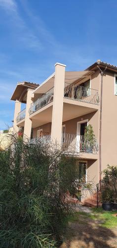 a building with balconies on the side of it at B&B I Colori di Chia in Chia