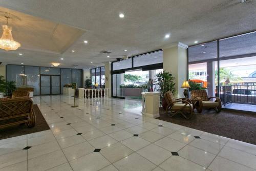 a lobby with a large room with chairs and tables at Royal Kuhio 2309 - Spacious Studio with Stunning Ocean Views in the Heart of Waikiki! in Honolulu
