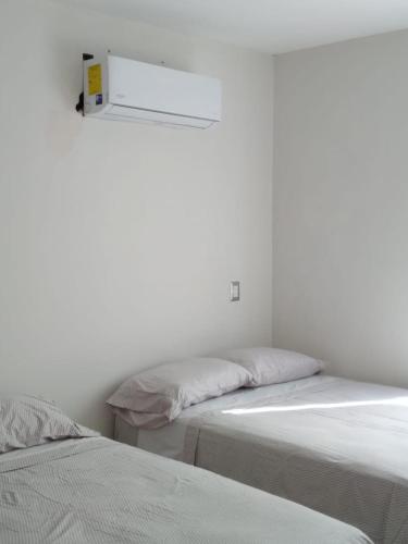 two beds sitting next to each other in a room at CASA CERRITOS MAZATLAN in Mazatlán