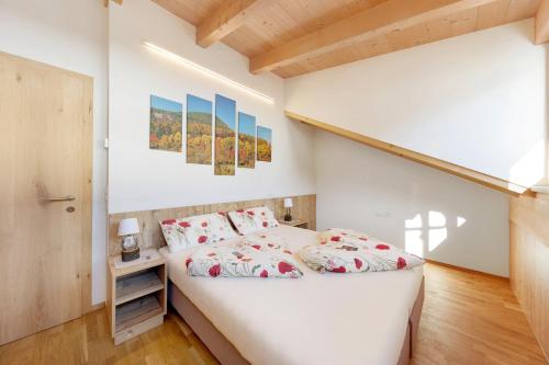 a bedroom with a white bed and a staircase at Töniglerhof Apt Morgensonne in Trodena