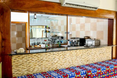 a kitchen with a counter and a counter top at Brisotel - Beira Mar in Luanda