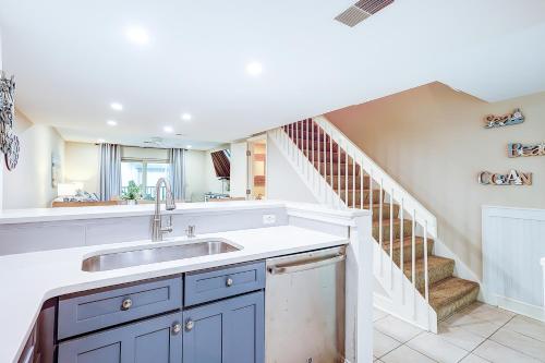 a kitchen with a sink and a staircase at Surf Court Villas 5 in Hilton Head Island