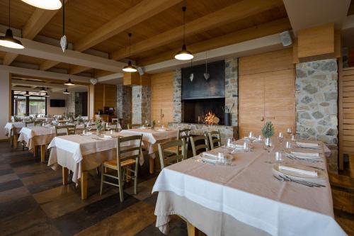 a restaurant with tables and chairs and a fireplace at Masseria Agriturismo Torre Di Albidona in Trebisacce