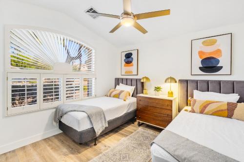 a bedroom with two beds and a ceiling fan at Paradise in the Valley in Phoenix