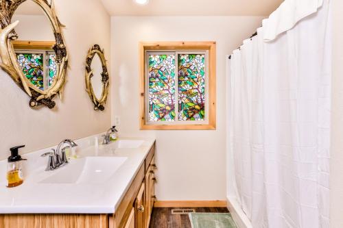a bathroom with a sink and a window at A Place To Gather in Tomahawk