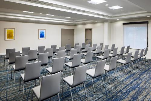 a room with rows of chairs in a classroom at Holiday Inn Express Hotel & Suites Port St. Lucie West by IHG in Port Saint Lucie