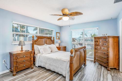 a bedroom with a bed and a ceiling fan at Norma on the Canal in Punta Gorda
