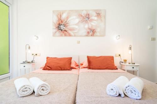 a bedroom with two beds with towels on them at Green Paradise in Mlini