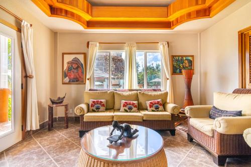 a living room with a couch and a table at Lighthouse Beach Villas in San Pedro