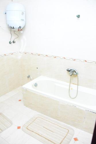 a bathroom with a bath tub in a room at Kenzy guest house in Cairo