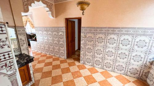 a room with a tile wall and a doorway at dar haut de gamme Et à un prix imaginaire Hostcom For families only in Oujda