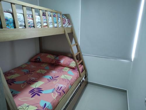 a bunk bed with a pillow on the bottom bunk at Apartamento Amoblado in Barranquilla