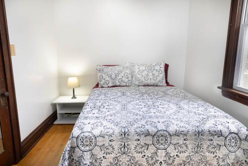 a bedroom with a bed with a blue and white comforter at 4 Bedroom House by Leavetown Vacations in Superior