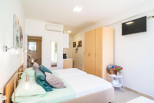 a small bedroom with a bed and a tv at Green Paradise in Mlini
