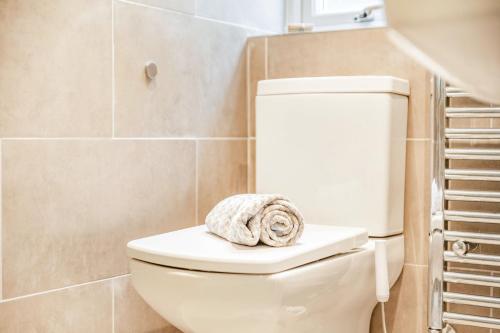a towel sitting on top of a toilet in a bathroom at Pier View in Weston-super-Mare