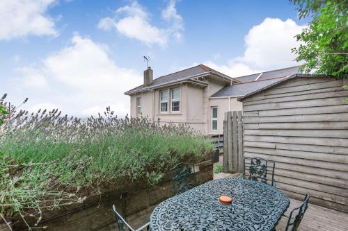 a table and chairs in front of a house at Pier View in Weston-super-Mare