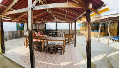 a patio with a table and chairs under a roof at Hostal Liwa Kashi in Ríohacha