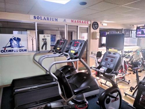 a gym with several cardio bikes in a room at Almond Business Hotel in Nicosia